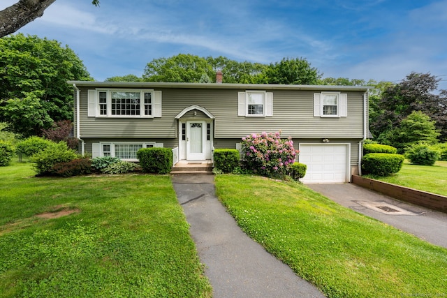 39 Ivy Dr, Southington, CT 06489 - bi-level home with asphalt driveway, an attached garage, and a front yard
