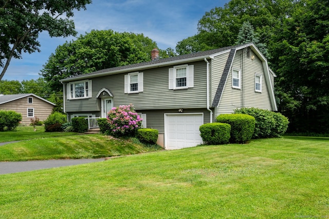 39 Ivy Dr, Southington, CT 06489 - bi-level home featuring a chimney, a garage, and a front lawn