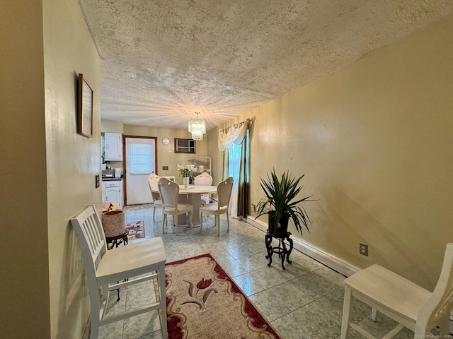 82 Louisiana Ave, Bridgeport, CT 06610 - tiled dining space featuring a chandelier, an AC wall unit, and baseboards