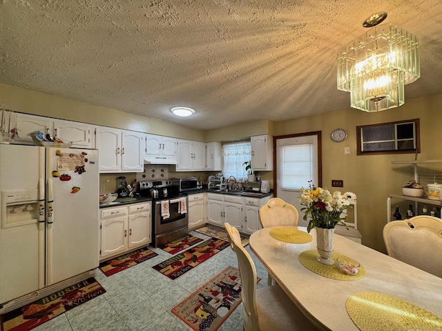 82 Louisiana Ave, Bridgeport, CT 06610 - kitchen featuring stainless steel appliances, dark countertops, white cabinetry, under cabinet range hood, and a textured ceiling