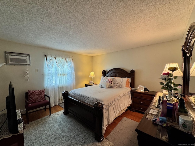 82 Louisiana Ave, Bridgeport, CT 06610 - bedroom with a wall unit AC, a textured ceiling, and dark wood finished floors