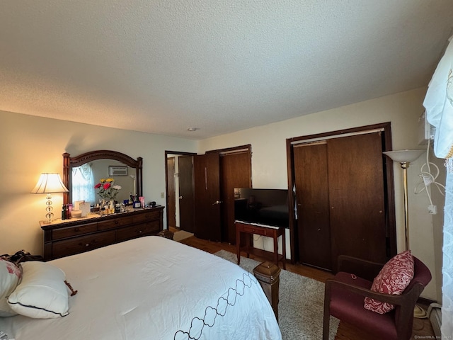 82 Louisiana Ave, Bridgeport, CT 06610 - bedroom featuring multiple closets and a textured ceiling