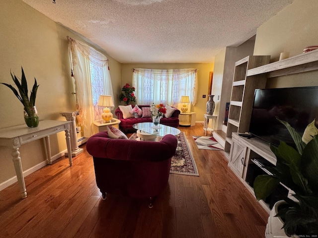 82 Louisiana Ave, Bridgeport, CT 06610 - living area featuring a textured ceiling, wood finished floors, and baseboards