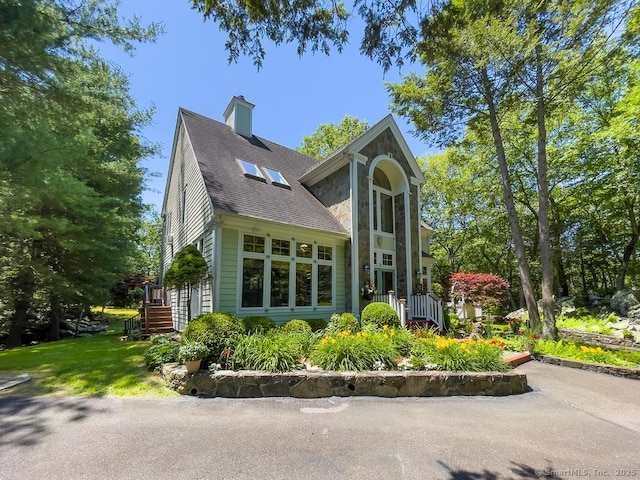 9A Obtuse Rocks Rd, Brookfield, CT 06804 - view of home's exterior featuring roof with shingles, a chimney, and stone siding
