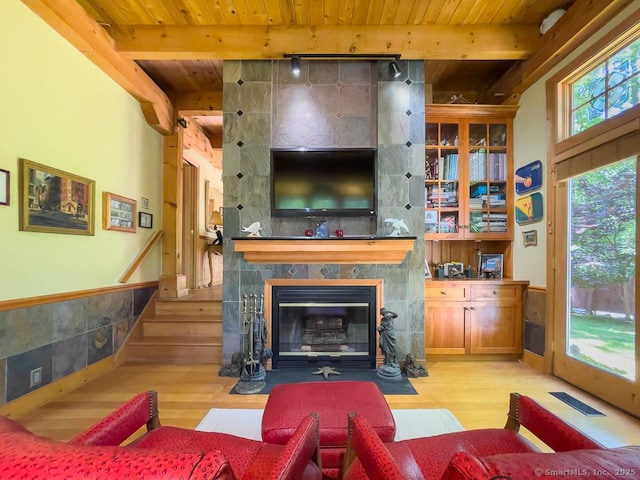 9A Obtuse Rocks Rd, Brookfield, CT 06804 - living room featuring a wood ceiling with exposed beams, light wood finished floors, a wainscoted wall, and a fireplace