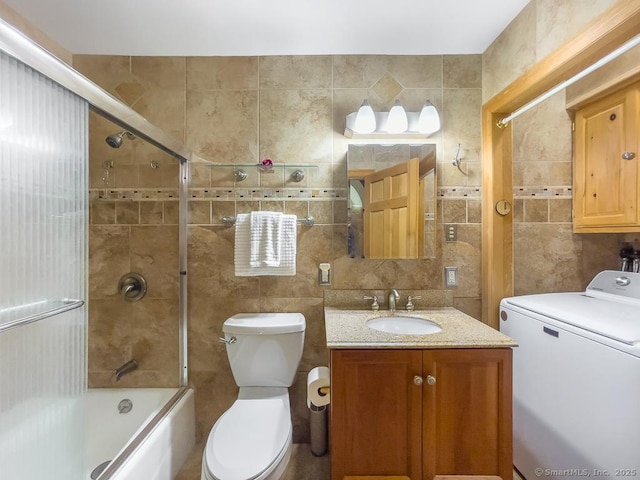 9A Obtuse Rocks Rd, Brookfield, CT 06804 - bathroom with washer / dryer, tile walls, vanity, bath / shower combo with glass door, and tasteful backsplash