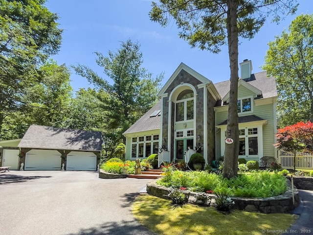 9A Obtuse Rocks Rd, Brookfield, CT 06804 - view of front of house featuring an outdoor structure, a garage, stone siding, and roof with shingles