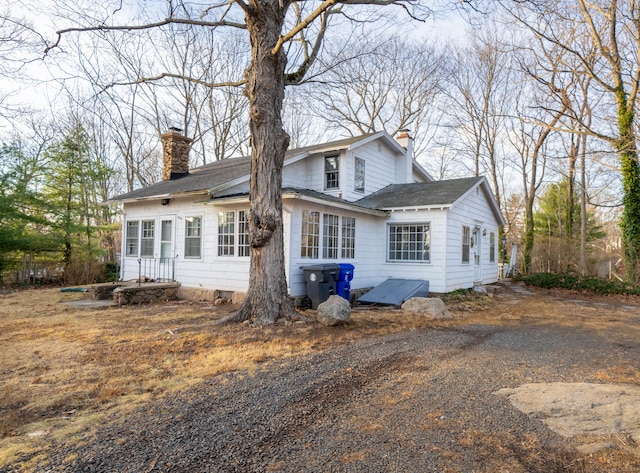 25 Gray Ledge Rd, Branford, CT 06405 - view of front facade with a chimney and roof with shingles
