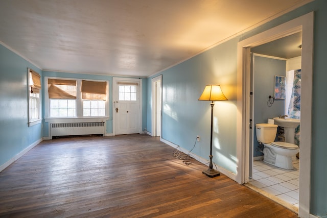 25 Gray Ledge Rd, Branford, CT 06405 - foyer entrance featuring radiator, crown molding, hardwood / wood-style floors, and baseboards