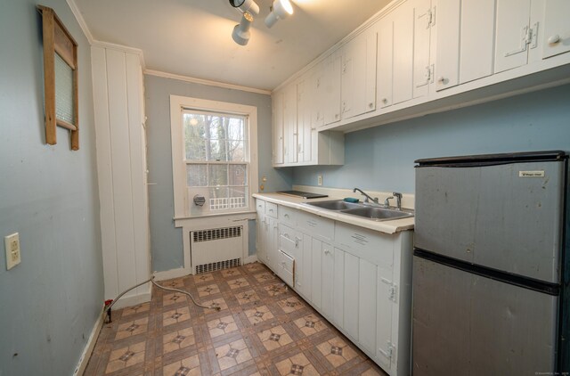 25 Gray Ledge Rd, Branford, CT 06405 - kitchen with radiator heating unit, a sink, freestanding refrigerator, light countertops, and white cabinets