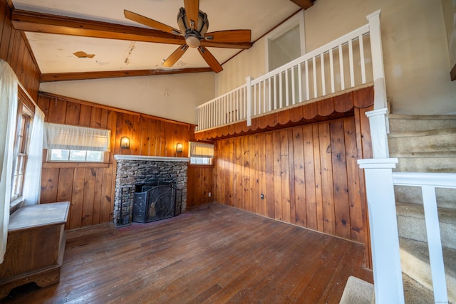 25 Gray Ledge Rd, Branford, CT 06405 - unfurnished living room featuring hardwood / wood-style floors, a stone fireplace, healthy amount of natural light, wood walls, and beamed ceiling