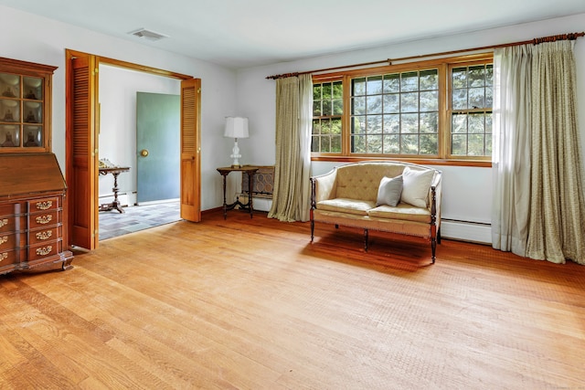475 Hoyt St, Darien, CT 06820 - sitting room with light wood-style flooring and a baseboard heating unit