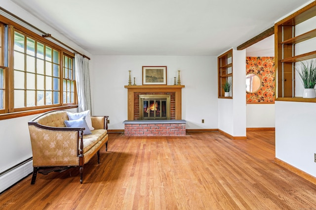 475 Hoyt St, Darien, CT 06820 - living area with a baseboard radiator, wood finished floors, baseboards, and a brick fireplace