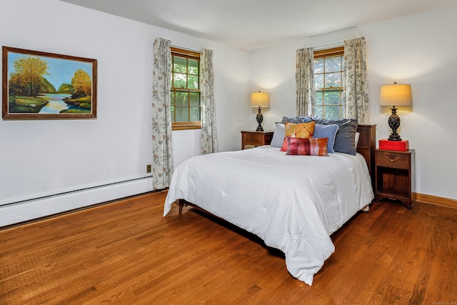 475 Hoyt St, Darien, CT 06820 - bedroom with wood finished floors, baseboard heating, and baseboards