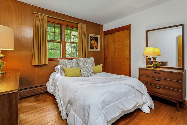 475 Hoyt St, Darien, CT 06820 - bedroom with a closet, wood finished floors, wooden walls, and baseboard heating