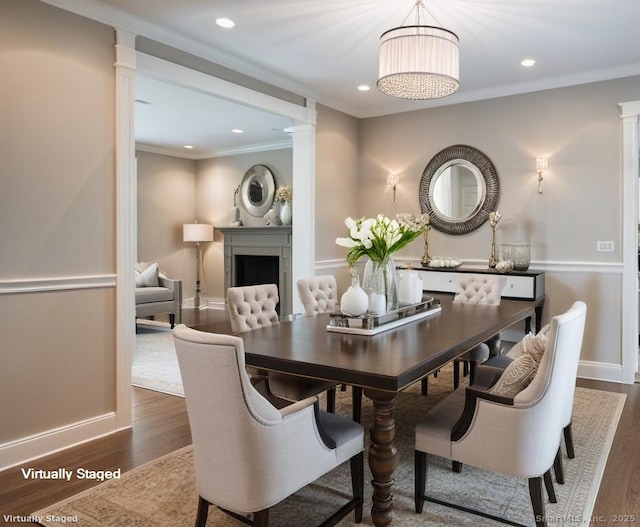 475 Hoyt St, Darien, CT 06820 - dining room with decorative columns, dark wood finished floors, a fireplace, recessed lighting, and ornamental molding