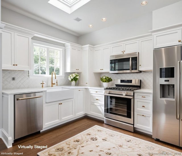 475 Hoyt St, Darien, CT 06820 - kitchen with stainless steel appliances, light countertops, dark wood finished floors, white cabinets, and recessed lighting