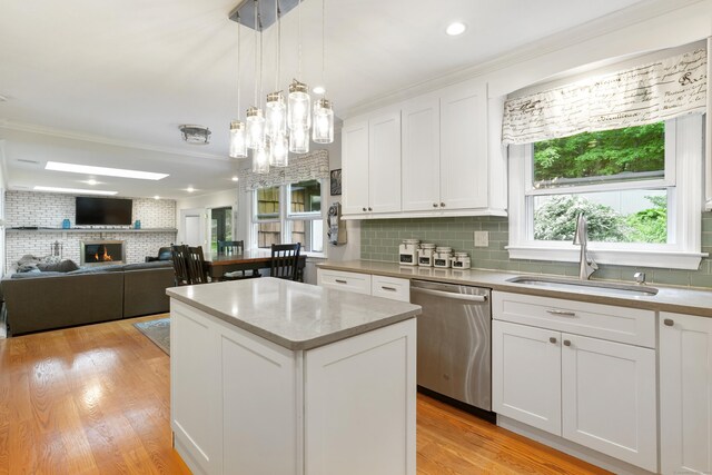 40 Spring Hill Ln, Bethel, CT 06801 - kitchen with stainless steel dishwasher, a sink, tasteful backsplash, ornamental molding, and a center island