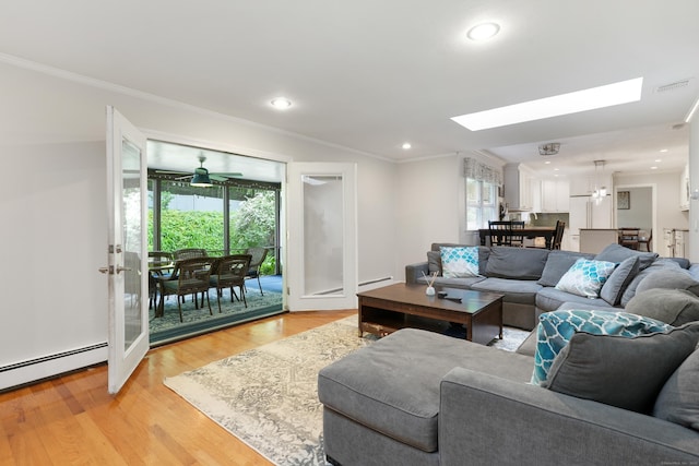 40 Spring Hill Ln, Bethel, CT 06801 - living area featuring healthy amount of natural light, a skylight, ornamental molding, light wood-style flooring, and baseboard heating