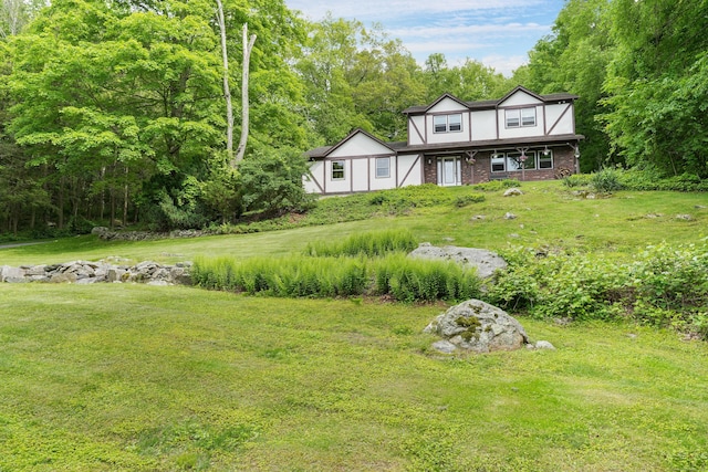 40 Spring Hill Ln, Bethel, CT 06801 - view of front of home with brick siding, a front lawn, and covered porch