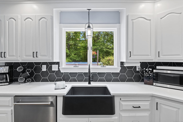 114 Dean Rd, East Lyme, CT 06333 - kitchen with stainless steel appliances, a sink, white cabinets, and backsplash