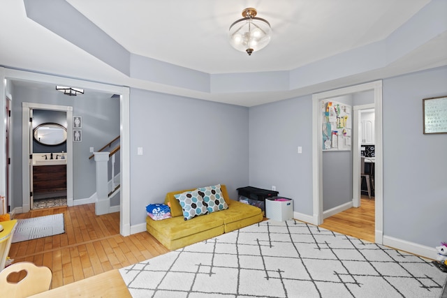114 Dean Rd, East Lyme, CT 06333 - living area featuring wood-type flooring, a raised ceiling, stairs, and baseboards
