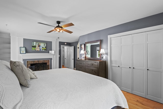 114 Dean Rd, East Lyme, CT 06333 - bedroom featuring light wood finished floors, a fireplace, and a ceiling fan