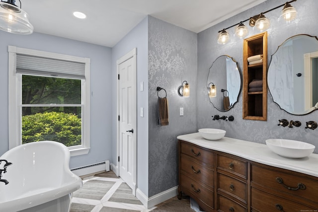 114 Dean Rd, East Lyme, CT 06333 - full bathroom with a baseboard heating unit, double vanity, a freestanding tub, baseboards, and recessed lighting