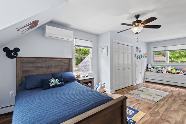 114 Dean Rd, East Lyme, CT 06333 - bedroom with a baseboard radiator, a wall unit AC, wood finished floors, ceiling fan, and lofted ceiling