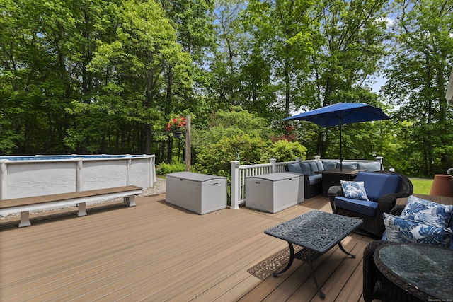 114 Dean Rd, East Lyme, CT 06333 - wooden deck with outdoor lounge area, an outdoor pool, and view of wooded area