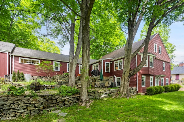 8 Cider Mill Rd, Tolland, CT 06084 - view of front of property with an outdoor fire pit, a front yard, and roof with shingles