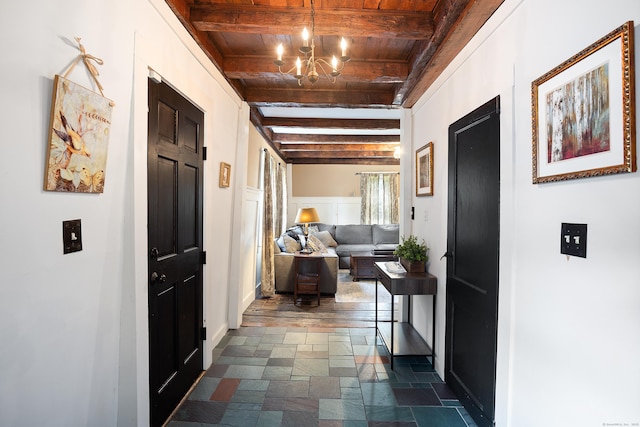8 Cider Mill Rd, Tolland, CT 06084 - corridor with wood ceiling with exposed beams, stone tile flooring, a chandelier, and baseboards