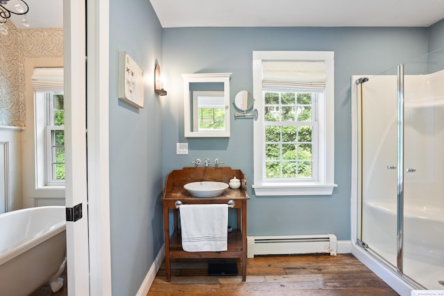 8 Cider Mill Rd, Tolland, CT 06084 - bathroom with a baseboard heating unit, wood-type flooring, a shower stall, vanity, and a soaking tub