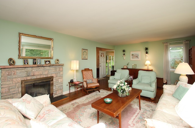 202 Wilson Rd, Orange, CT 06477 - living area featuring wood finished floors, a stone fireplace, and baseboards