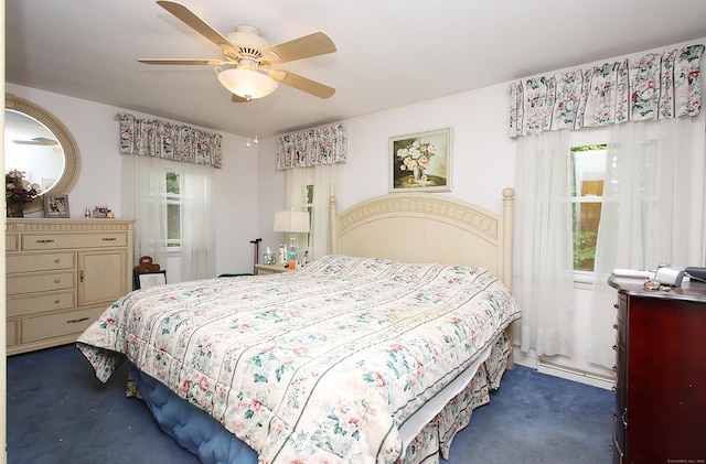 202 Wilson Rd, Orange, CT 06477 - bedroom featuring a baseboard heating unit, ceiling fan, and dark colored carpet
