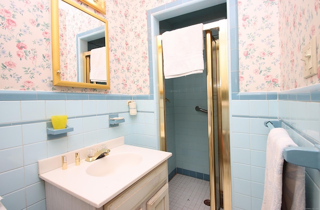 202 Wilson Rd, Orange, CT 06477 - bathroom featuring wallpapered walls, tile walls, wainscoting, a stall shower, and vanity