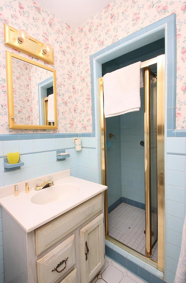 202 Wilson Rd, Orange, CT 06477 - full bathroom featuring wallpapered walls, vanity, wainscoting, a shower stall, and tile walls