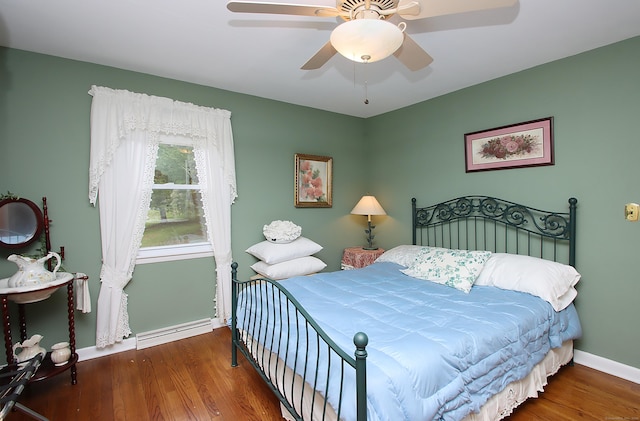 202 Wilson Rd, Orange, CT 06477 - bedroom featuring wood finished floors, baseboards, a ceiling fan, and a baseboard heating unit
