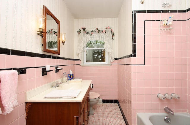 202 Wilson Rd, Orange, CT 06477 - full bathroom featuring wallpapered walls, vanity, tile walls, toilet, and a wainscoted wall