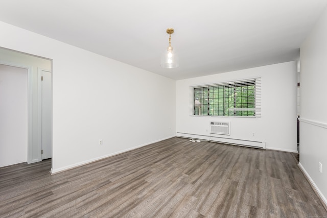 125 Warner Hill Rd Unit 74, Stratford, CT 06614 - spare room with wood finished floors, baseboard heating, an AC wall unit, and baseboards
