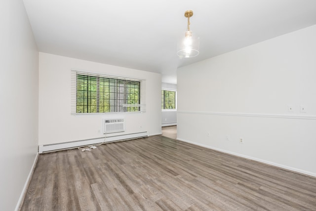 125 Warner Hill Rd Unit 74, Stratford, CT 06614 - empty room with baseboard heating, wood finished floors, baseboards, a baseboard heating unit, and a wall unit AC