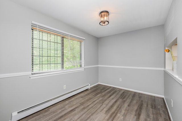 125 Warner Hill Rd Unit 74, Stratford, CT 06614 - spare room with baseboard heating, wood finished floors, and baseboards