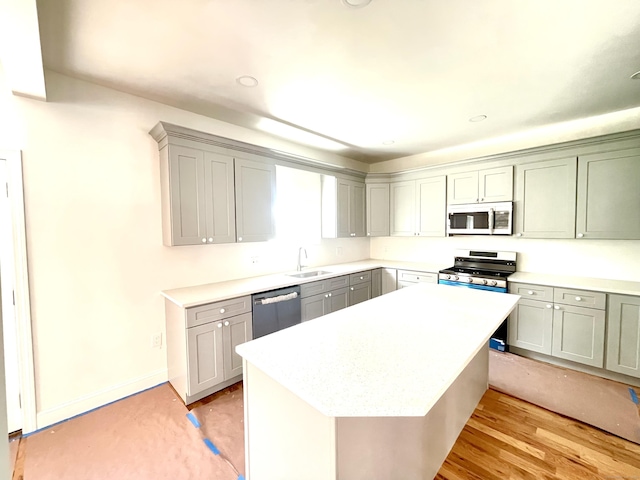 277 Trumbull Ave, Bridgeport, CT 06606 - kitchen with appliances with stainless steel finishes, a sink, light countertops, a kitchen island, and gray cabinets