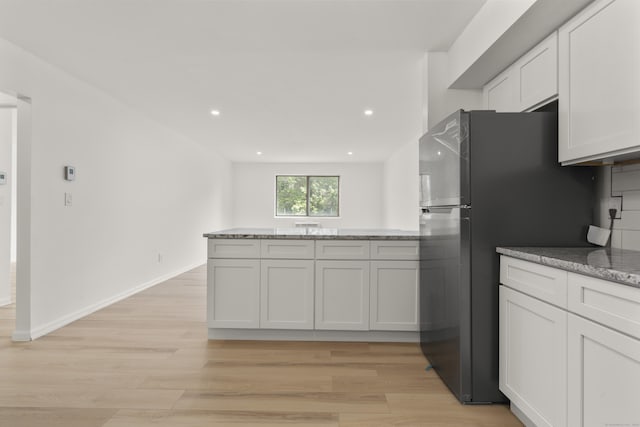 79 Claudia Dr Apt 254, West Haven, CT 06516 - kitchen featuring freestanding refrigerator, light wood-style flooring, a peninsula, light stone countertops, and recessed lighting