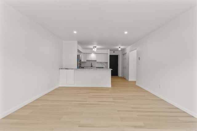 79 Claudia Dr Apt 254, West Haven, CT 06516 - kitchen featuring freestanding refrigerator, a peninsula, decorative backsplash, baseboards, and recessed lighting