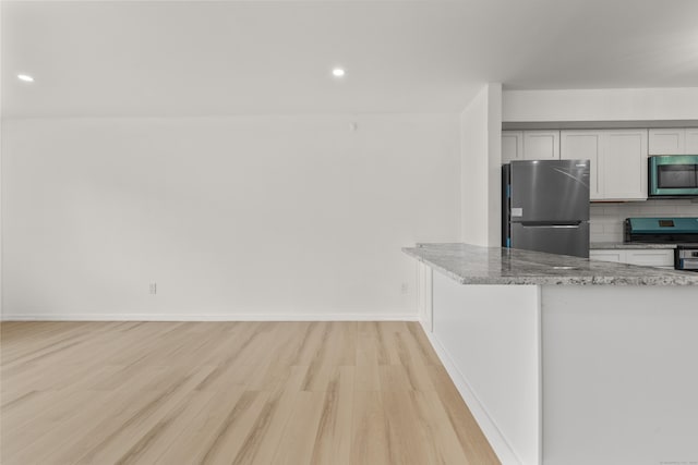 79 Claudia Dr Apt 254, West Haven, CT 06516 - kitchen with stainless steel appliances, light wood-type flooring, decorative backsplash, light stone countertops, and recessed lighting