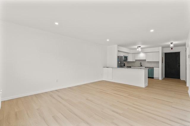 79 Claudia Dr Apt 254, West Haven, CT 06516 - unfurnished living room featuring light wood finished floors, a sink, recessed lighting, and baseboards