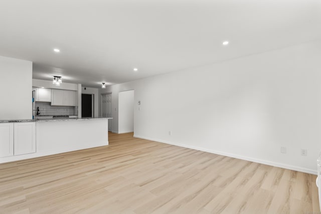 79 Claudia Dr Apt 254, West Haven, CT 06516 - unfurnished living room with light wood finished floors, recessed lighting, and baseboards