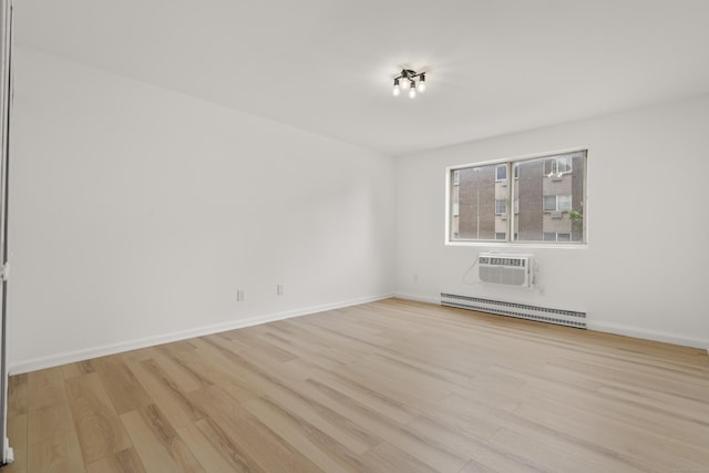 79 Claudia Dr Apt 254, West Haven, CT 06516 - empty room with a baseboard radiator, wood finished floors, a wall mounted AC, and baseboards