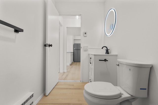 79 Claudia Dr Apt 254, West Haven, CT 06516 - half bath featuring toilet, wood finished floors, baseboard heating, and vanity